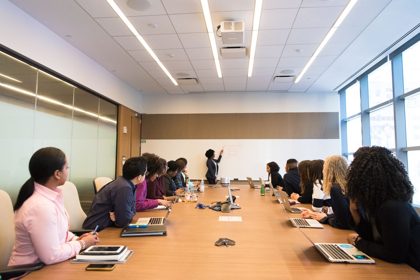 Black and brown colleagues working together around a table